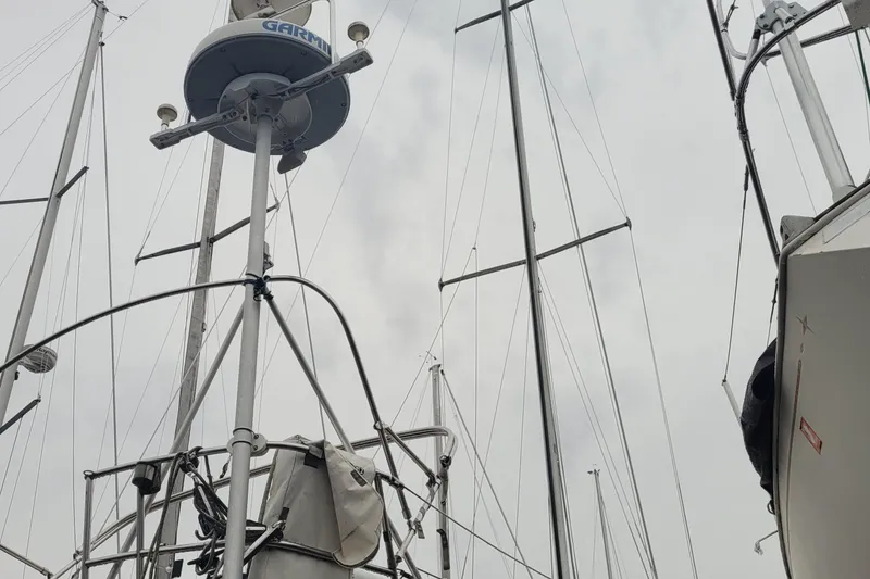 Slide: The Image of Masts and rigging of a 1986 Sabre 34 sailboat against a cloudy sky. - 7