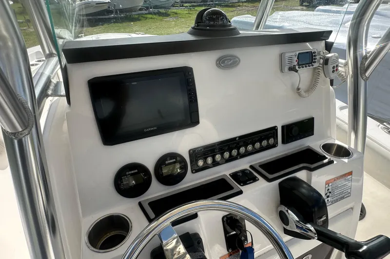 Slide: The Image of 2023 Sea Fox 228 Commander dashboard with Garmin display and Yamaha controls. - 14