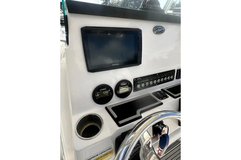 Slide: The Image of 2023 Sea Fox 228 Commander dashboard with Garmin display and controls. - 15