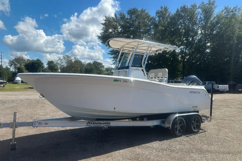Slide: The Image of 2023 Sea Fox 228 Commander boat on trailer, parked outdoors under a blue sky. - 24