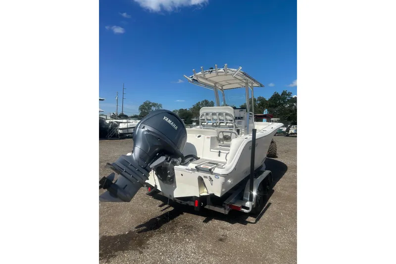 Slide: The Image of 2023 Sea Fox 228 Commander boat with Yamaha outboard motor, parked on a trailer. - 28
