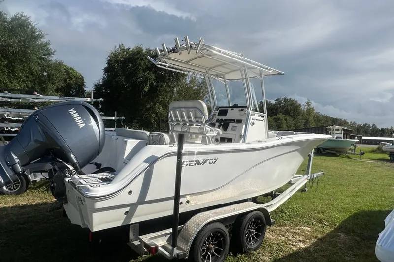 Slide: The Image of 2023 Sea Fox 228 Commander boat on trailer with Yamaha engine, parked on grass. - 3