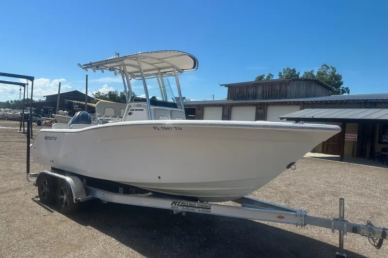 Slide: The Image of 2023 Sea Fox 228 Commander boat on trailer, parked outdoors under clear blue sky. - 31