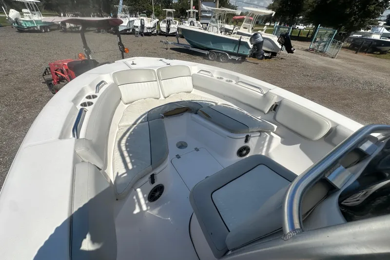 Slide: The Image of 2023 Sea Fox 228 Commander boat interior with seating and cup holders, parked outdoors. - 40