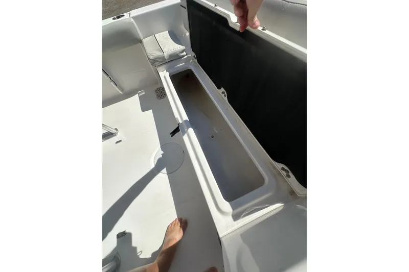 Slide: The Image of 2023 Sea Fox 228 Commander boat storage compartment with open lid, showcasing interior space. - 52