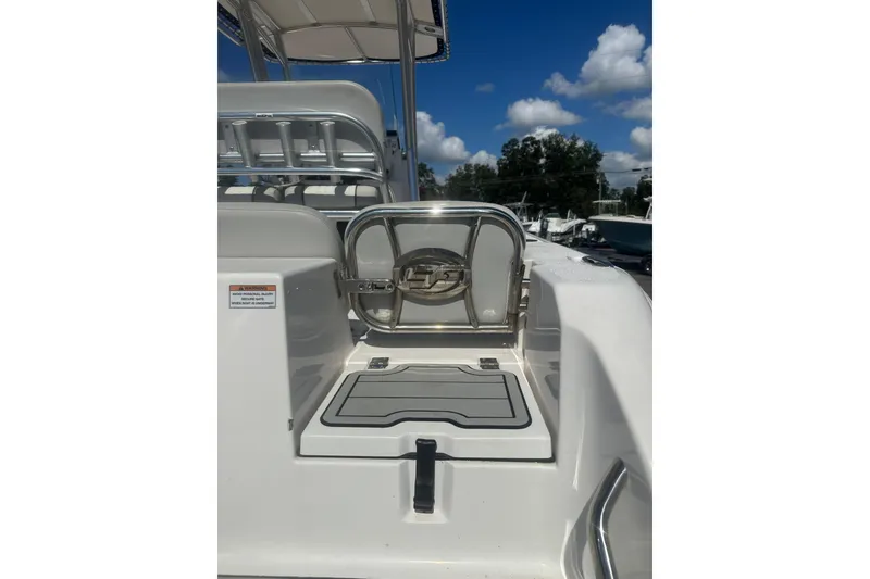 Slide: The Image of 2023 Sea Fox 228 Commander boat interior with seating and storage, under a clear blue sky. - 60