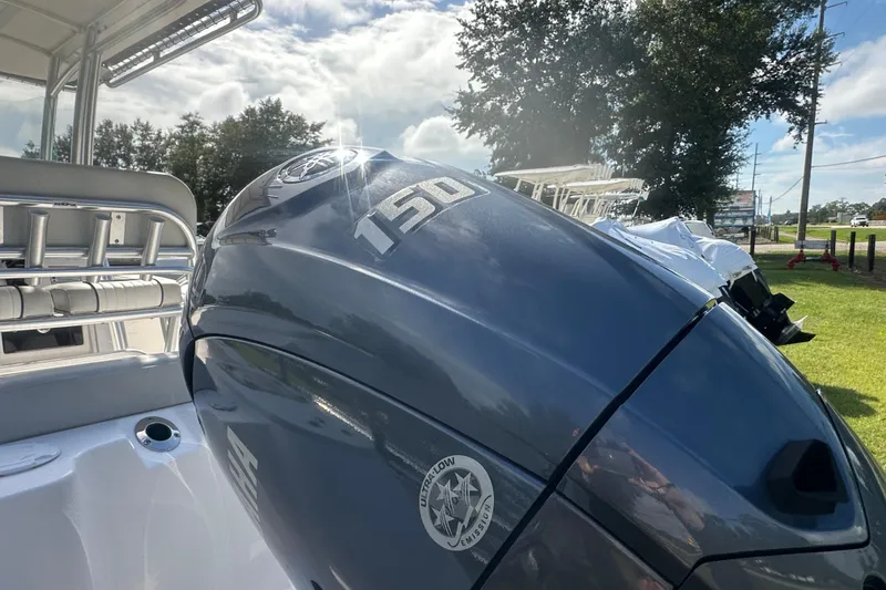 Slide: The Image of 2023 Sea Fox 228 Commander boat with powerful 150 horsepower engine, under sunny sky. - 7