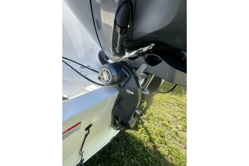 Slide: The Image of 2023 Sea Fox 228 Commander boat engine detail on grassy surface. - 8