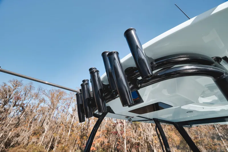 Slide: The Image of 2026 Front Runner 39' Center Console boat with rod holders against clear sky. - 11
