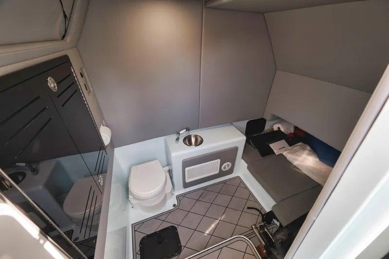 Slide: The Image of 2026 Front Runner 39' Center Console interior with toilet, sink, and storage area. - 22