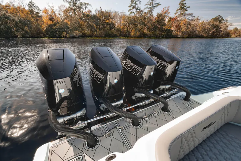 Slide: The Image of 2026 Front Runner 39' Center Console with four powerful outboard engines on a serene lake. - 24