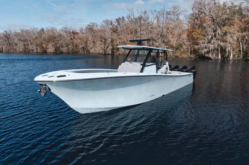 Slide: The Image of 2026 Front Runner 39' Center Console boat on a serene lake with autumn trees. - 4