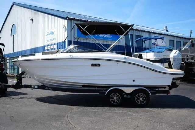 The Image of 2026 Sea Ray SPX 210 boat on trailer outside dealership. - 18