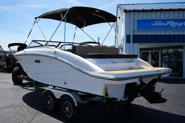 Slide: The Image of 2026 Sea Ray SPX 210 boat on trailer, parked outside dealership. - 24