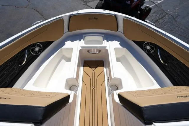 Slide: The Image of 2026 Sea Ray SPX 210 boat interior with tan and black seating, sleek design. - 27