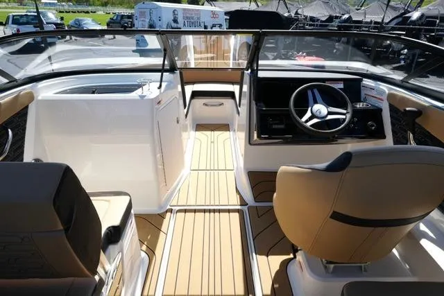Slide: The Image of Interior view of 2026 Sea Ray SPX 210 boat, featuring sleek design and modern controls. - 29