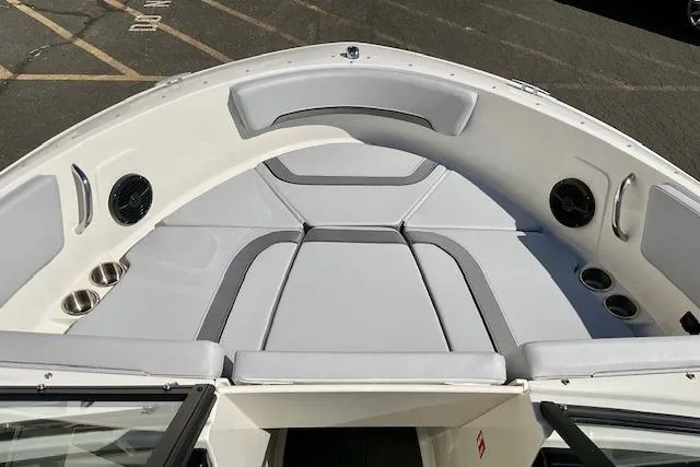 Slide: The Image of 2025 Bayliner V20 boat interior with cushioned seating and cup holders. - 12