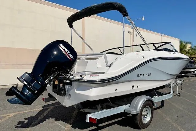 Slide: The Image of 2025 Bayliner V20 boat on trailer with Mercury outboard motor, parked outdoors. - 18