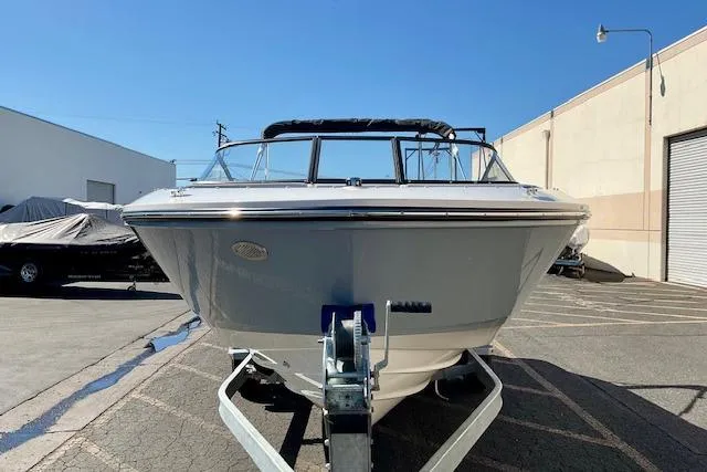 Slide: The Image of 2025 Bayliner V20 boat on trailer in sunny outdoor setting. - 2