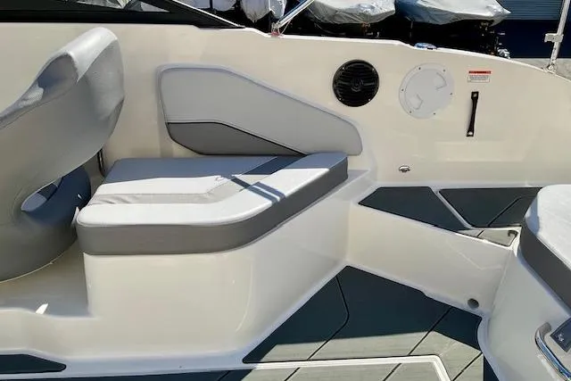 Slide: The Image of 2025 Bayliner V20 boat interior with gray seating and modern design elements. - 5