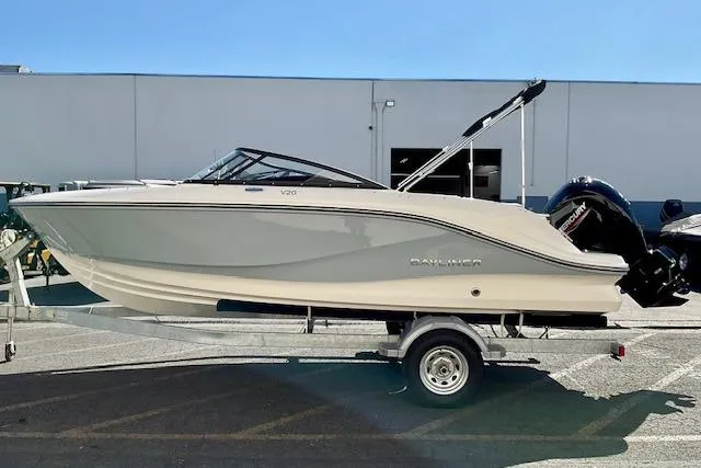 Slide: The Image of 2025 Bayliner V20 boat on trailer, parked outdoors, side view. - 14