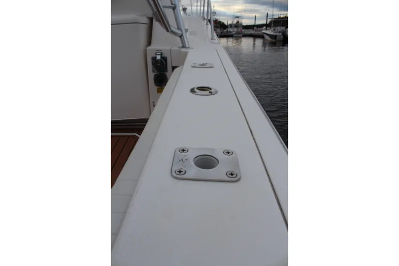Slide: The Image of 2005 Rampage 38 Express boat deck with rod holders, docked at marina. - 12