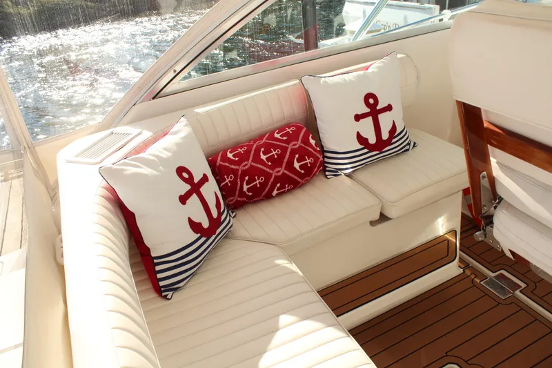 Slide: The Image of Luxurious 2005 Rampage 38 Express boat interior with nautical-themed cushions and elegant seating. - 15