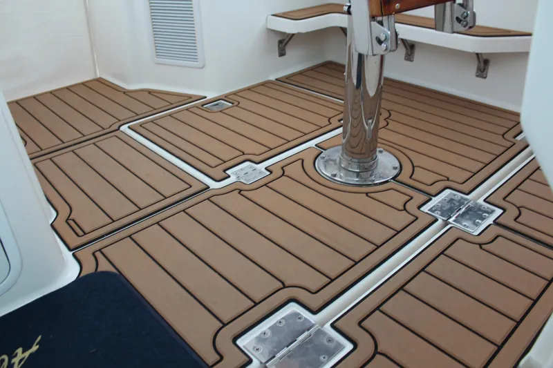 Slide: The Image of 2005 Rampage 38 Express boat deck with teak-style flooring and metal fixtures. - 19