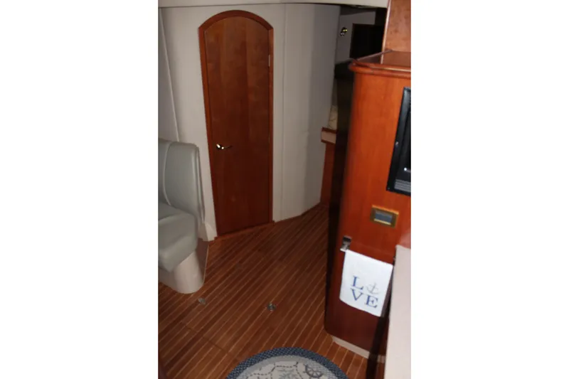 Slide: The Image of Interior of 2005 Rampage 38 Express yacht with wooden flooring and cozy seating. - 27