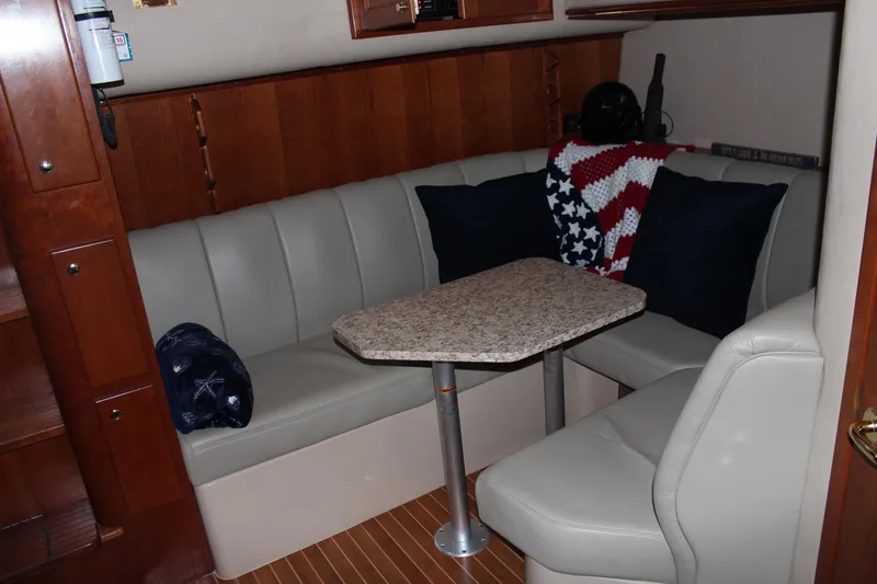 Slide: The Image of 2005 Rampage 38 Express cabin with cozy seating and a small table. - 29