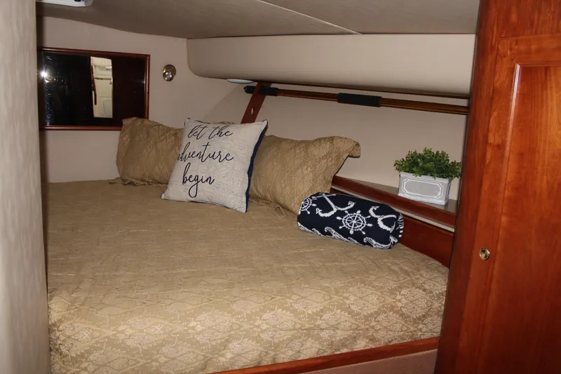 Slide: The Image of Cozy cabin interior of 2005 Rampage 38 Express with decorative pillows and bedding. - 30