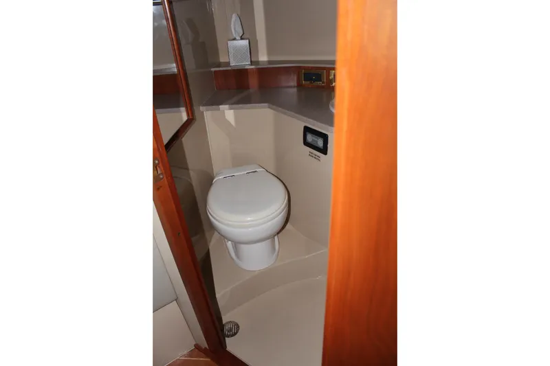 Slide: The Image of 2005 Rampage 38 Express boat bathroom with toilet and countertop. - 33