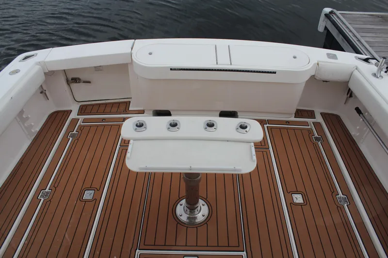 Slide: The Image of 2005 Rampage 38 Express boat deck with teak flooring and fishing rod holders. - 4