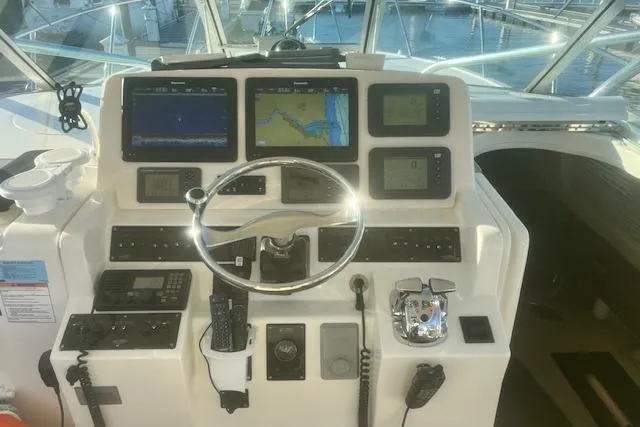 Slide: The Image of Control panel of a 2005 Rampage 38 Express boat with navigation screens and instruments. - 42