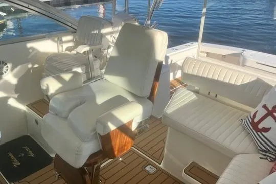Slide: The Image of 2005 Rampage 38 Express boat interior with white seating and wooden flooring. - 43