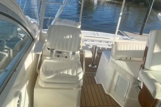 Slide: The Image of 2005 Rampage 38 Express boat interior with white seating and wooden flooring. - 45