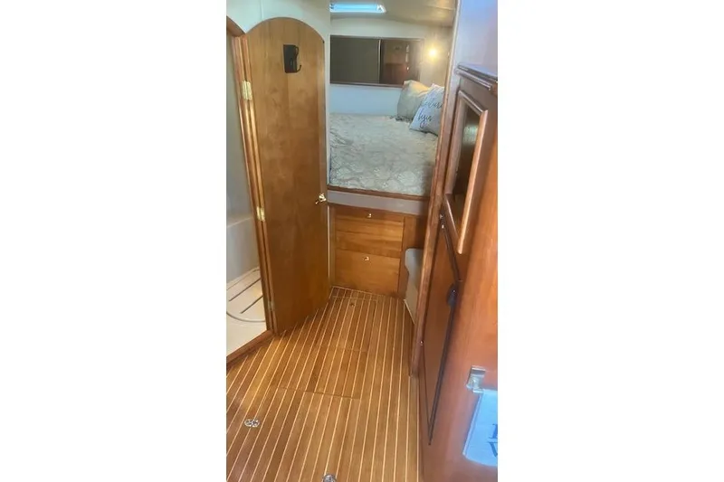 Slide: The Image of 2005 Rampage 38 Express cabin interior with wood flooring and cozy bed. - 46