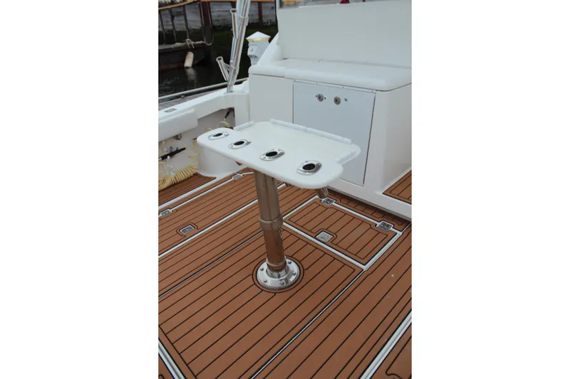 Slide: The Image of 2005 Rampage 38 Express boat deck with rod holders and teak flooring. - 6