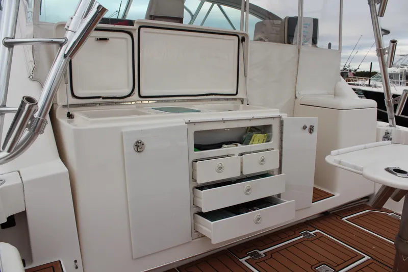 Slide: The Image of 2005 Rampage 38 Express boat interior with open storage drawers and cabinets. - 7