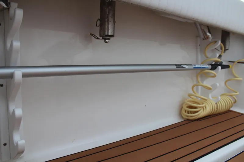 Slide: The Image of 2005 Rampage 38 Express boat interior with mounted rod and coiled hose. - 8
