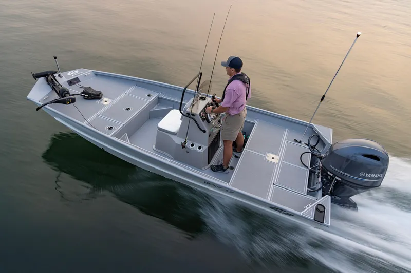Slide: The Image of 2026 G3 Bay 17 boat cruising on water with a person steering. - 19