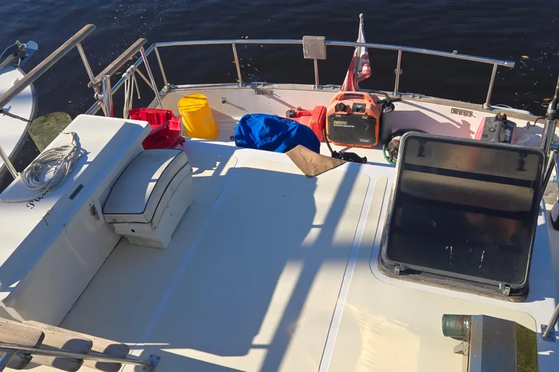 Slide: The Image of 1983 Custom Present 38 Double Cabin Trawler deck with equipment and storage. - 13