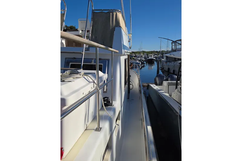 Slide: The Image of 1983 Custom Present 38 Double Cabin Trawler docked at marina, side view. - 15