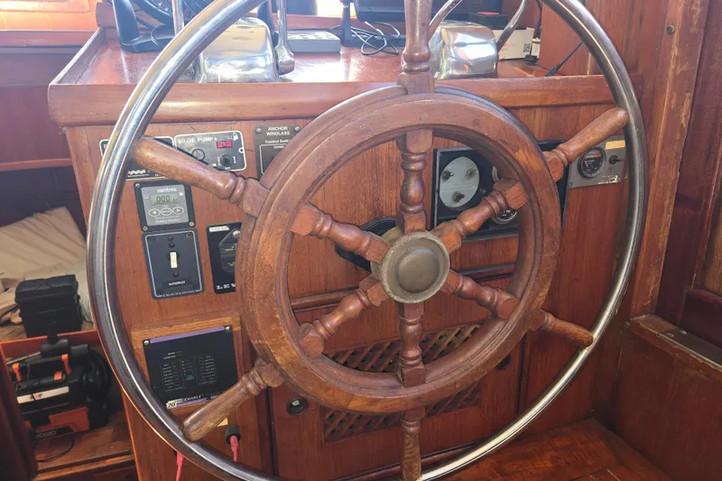 Slide: The Image of Wooden steering wheel of 1983 Custom Present 38 Double Cabin Trawler, showcasing nautical controls. - 20