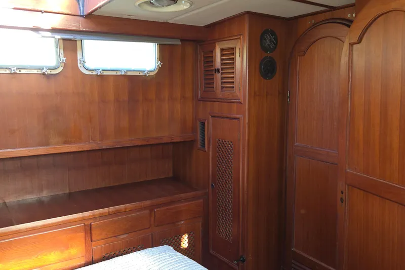 Slide: The Image of 1983 Custom Present 38 Double Cabin Trawler interior with wooden cabinetry and windows. - 21