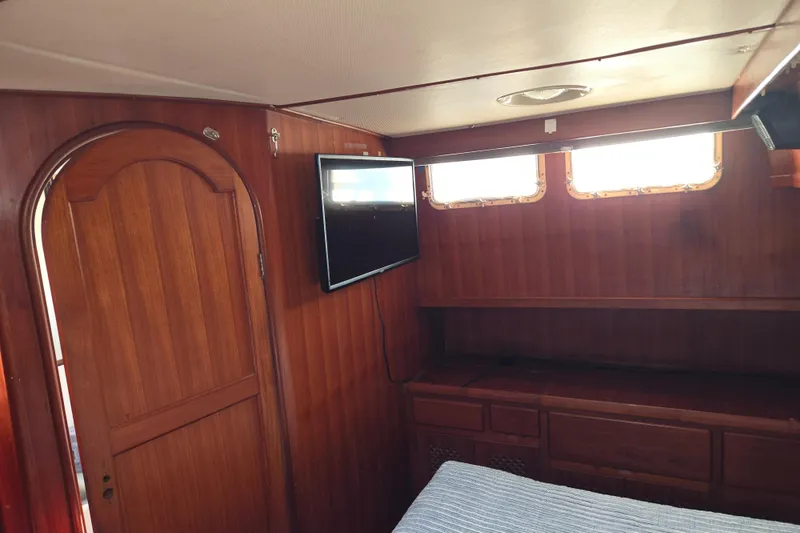 Slide: The Image of Interior of 1983 Custom Present 38 Double Cabin Trawler with wood paneling and TV. - 22