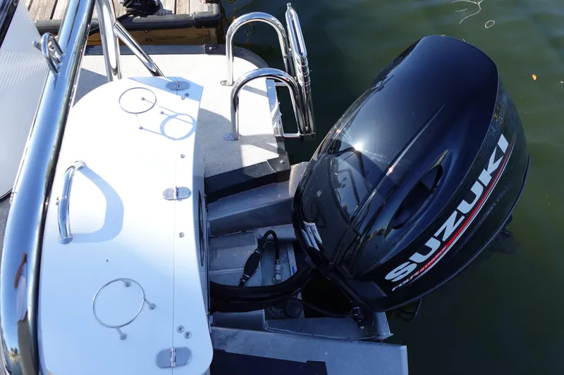 Slide: The Image of 2020 Tahoe Pontoon 2485 LTZ with Suzuki outboard motor at dock. - 11