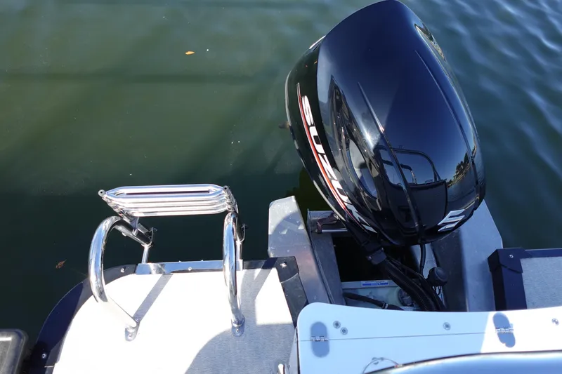 Slide: The Image of 2020 Tahoe Pontoon 2485 LTZ Rear Lounger with Suzuki outboard motor and swim ladder. - 12