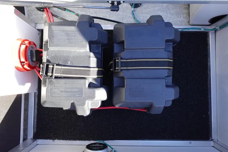 Slide: The Image of Battery compartment of 2020 Tahoe Pontoon 2485 LTZ Rear Lounger with protective boxes. - 15