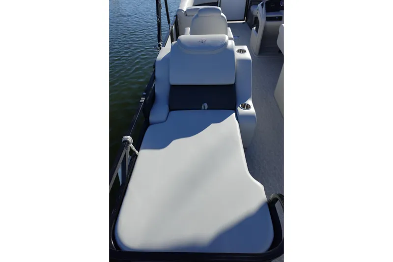 Slide: The Image of 2020 Tahoe Pontoon 2485 LTZ Rear Lounger, featuring comfortable seating on a sunny day. - 16